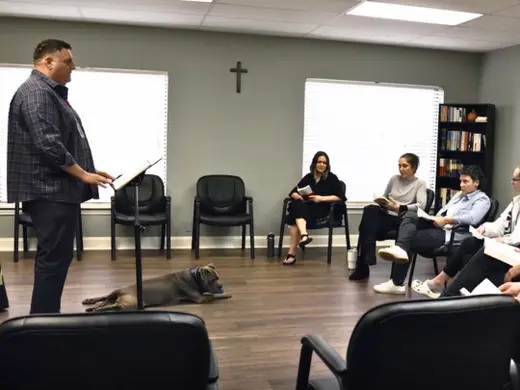 Group therapy session with a facilitator at Faith in Recovery detox center in Miami.