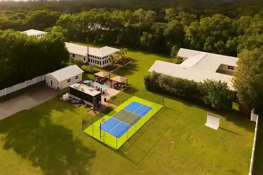 Aerial view of landscaped grounds with tennis courts at The Haven Detox, a premier alcohol and drug rehab center in Miami.