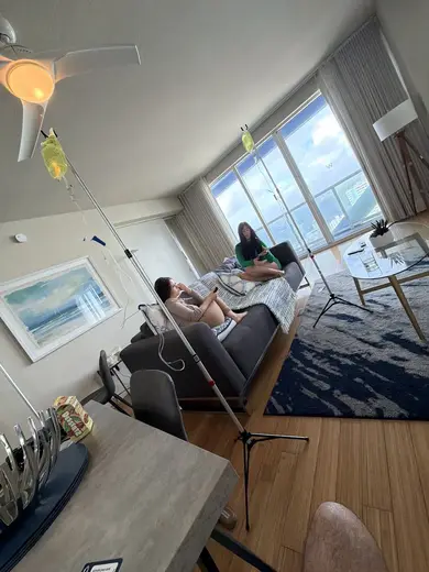 Bright living room with IV drips at Liquivida Brickell by Mesalogy Health, a detox center in Miami.