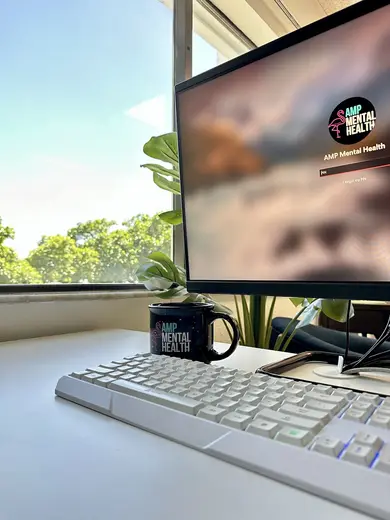 Bright workspace with computer and plant at AMP Mental Health, a partial hospitalization program in Miami.