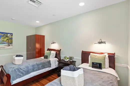 Cozy bedroom with two beds at Amethyst Recovery Center, a treatment center in Miami.