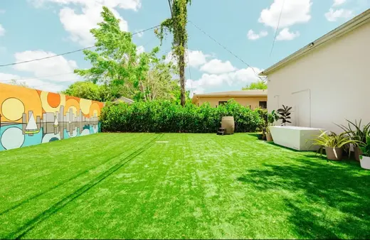 Landscaped backyard with vibrant mural at PARC - Premier Athletic Rehab Center, a treatment center in Miami.